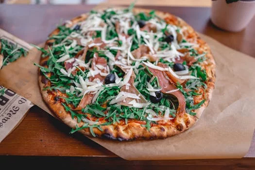 gourmet pizza with arugula and prosciutto